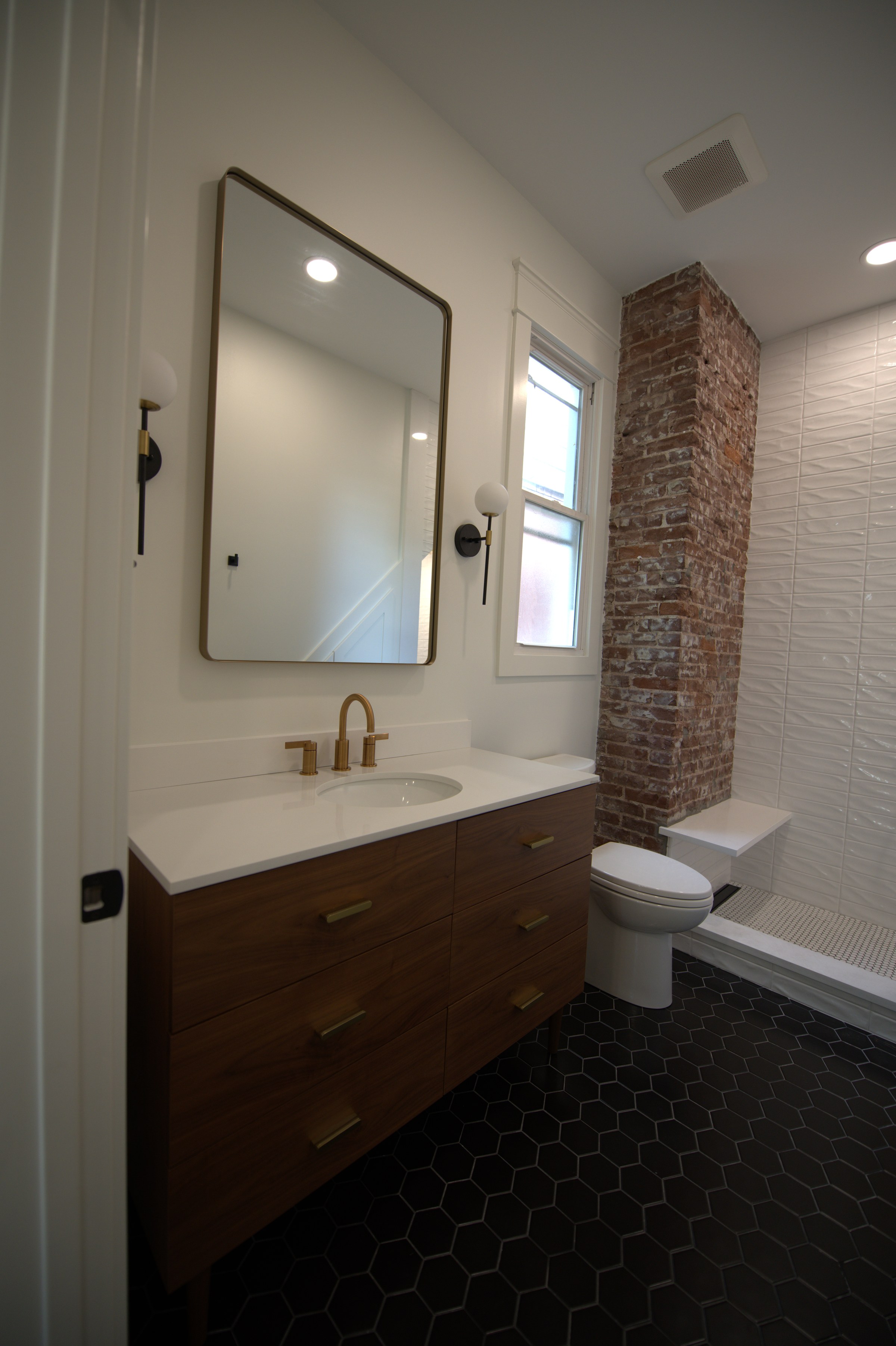 Powder room vanity with mirror and sconce