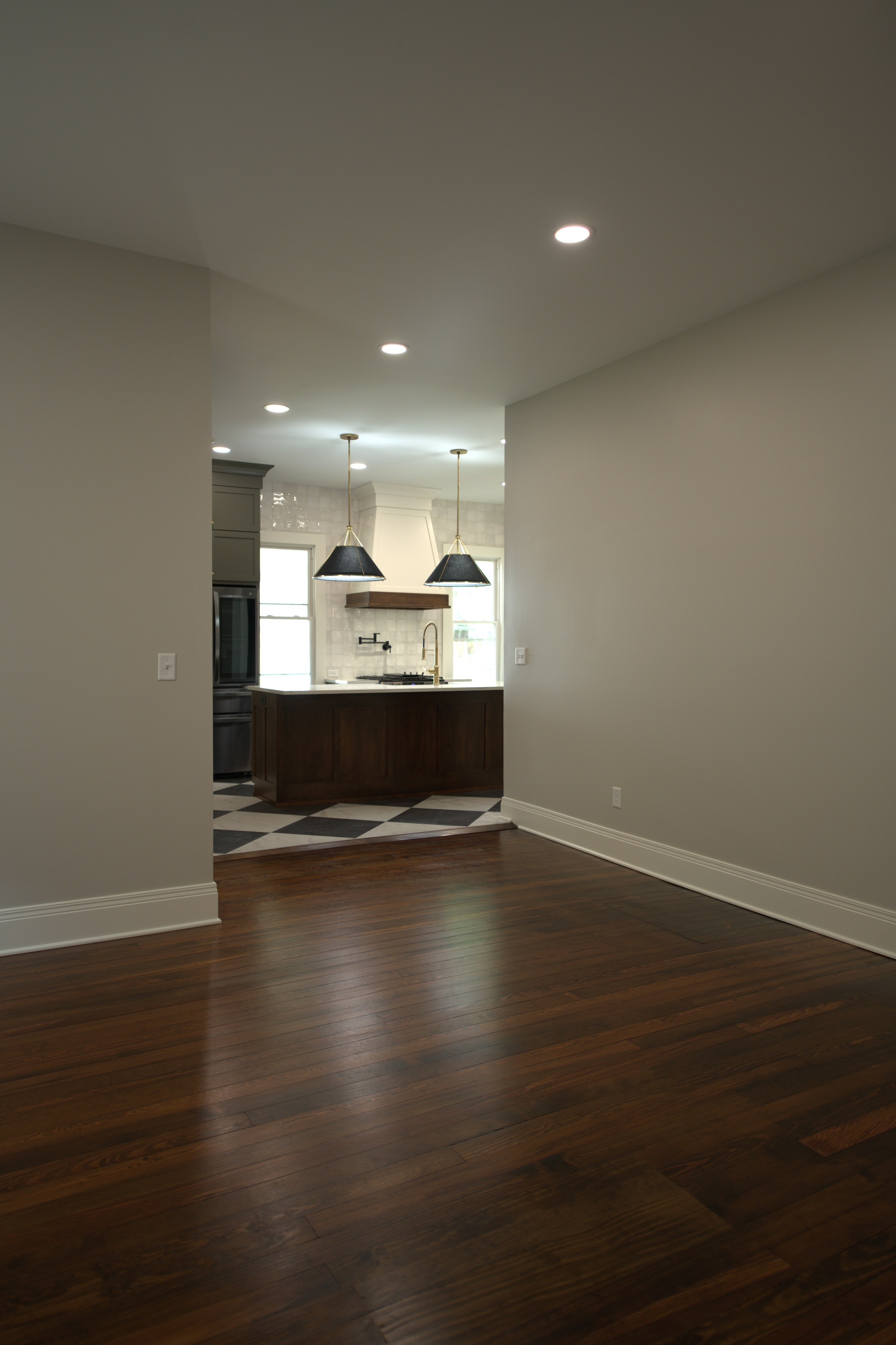Hallway with hardwood floors and open door