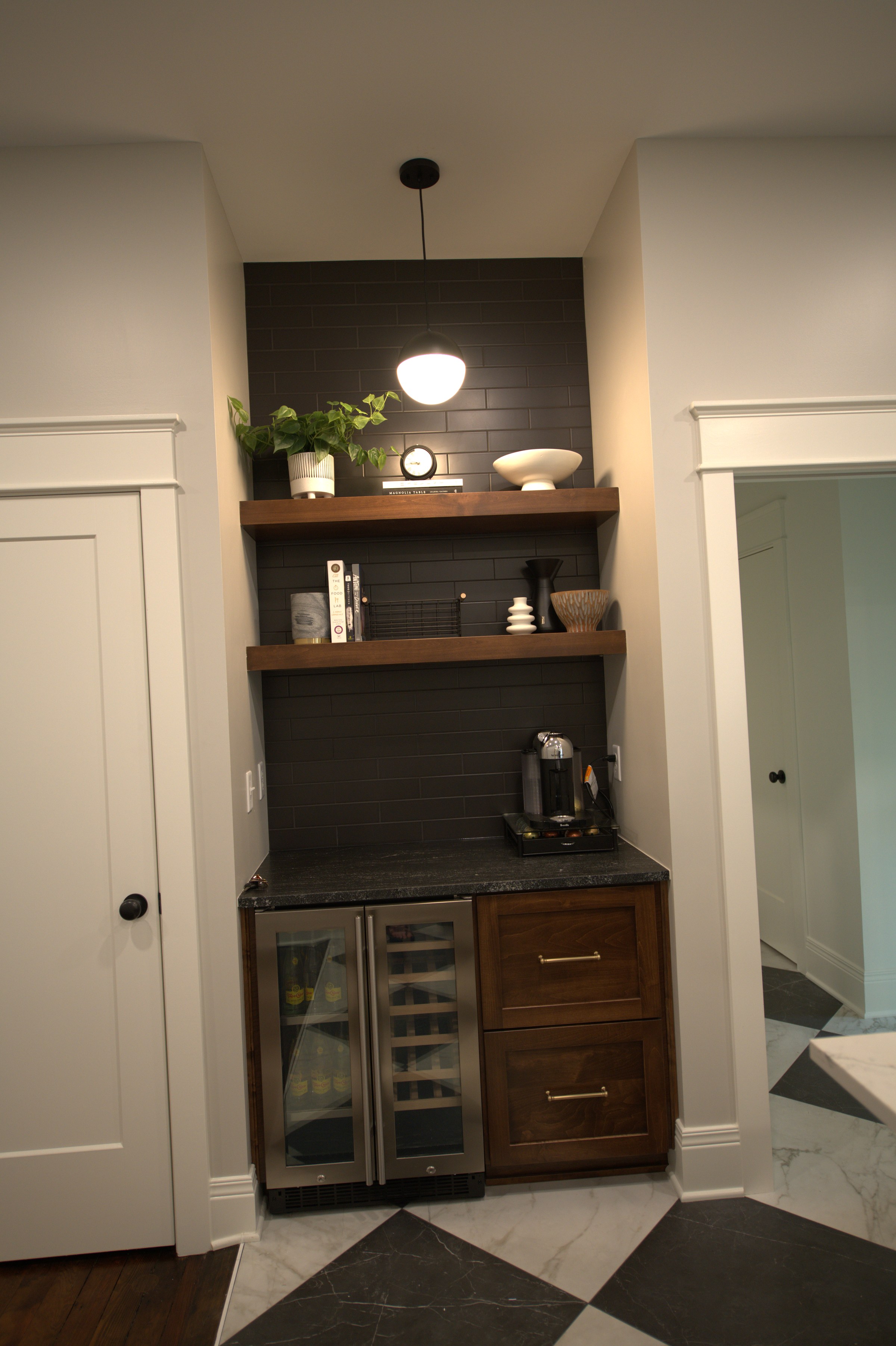 Built-in shelving nook with brass sconce